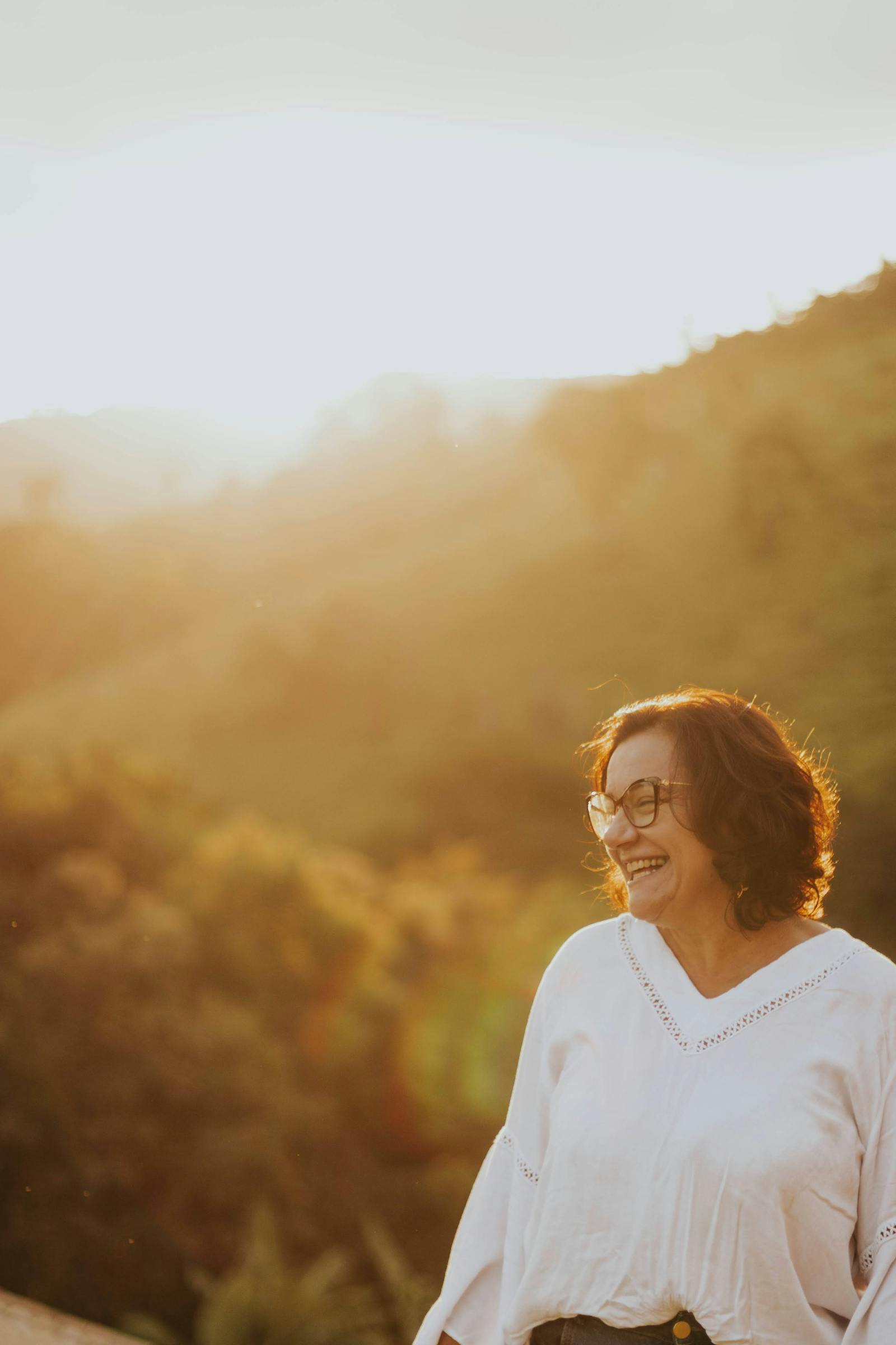 Femme épanouie dans la campagne, image symbolisant l'équilibre retrouvé